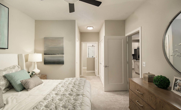 Bedroom with ensuite bath and ceiling fan at Camden Clearwater apartments in Clearwater, FL