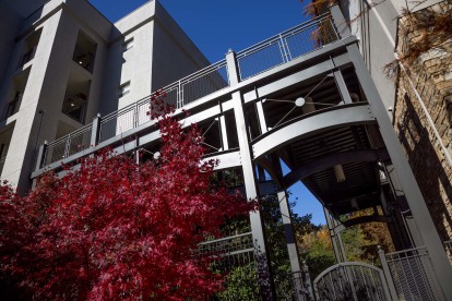 Outdoor walkway from covered parking garage to midrise apartments