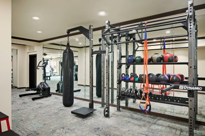 24-hour fitness center with cardio equipment and free weights at Camden Heights Apartments in Houston, TX