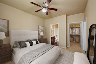Bedroom with carpet, ceiling fan, walk-in closet, and ensuite bathroom at Camden Brushy Creek apartments in Cedar Park, TX