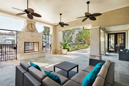 Exterior fireplace with lounge seating at Camden Northpointe Apartments in Tomball, TX