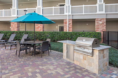 Outdoor grilling by the resort-style pool with dining at Camden Heights Apartments in Houston, Tx