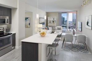 Kitchen, living area, and private balcony at Camden Pier District high-rise apartments in St. Petersburg, FL