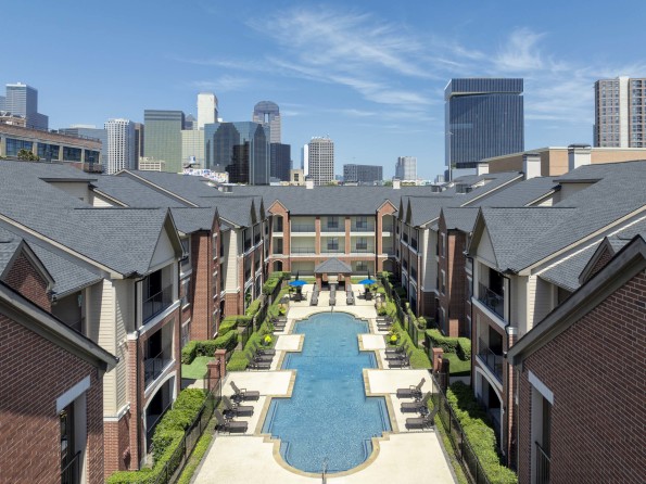 Aerial view of Pool 1 with the Dallas skyline in the background at Camden Farmers Market apartments in Dallas, TX