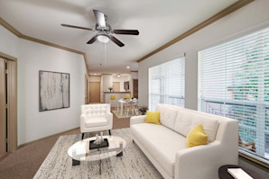 Open-concept living room with large windows and natural lighting at Camden Greenway Apartments in Houston, TX