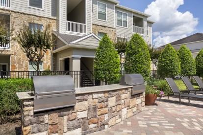 Outdoor grills and dining area at Camden Downs at Cinco Ranch Apartments in Katy, TX. 