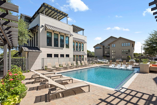 Villas pool and sundeck next to the amenity building at Camden Greenville apartments in Dallas, TX
