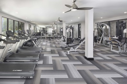 24-hour fitness center with strength and cardio equipment at Camden Design District apartments in Dallas, TX