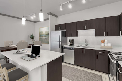 Large kitchen with stainless steel appliances and center island at Camden Asbury Village in Raleigh, NC