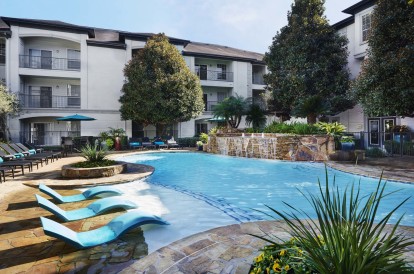 Resort-style pool with sun loungers at Camden Midtown Apartments in Houston, TX