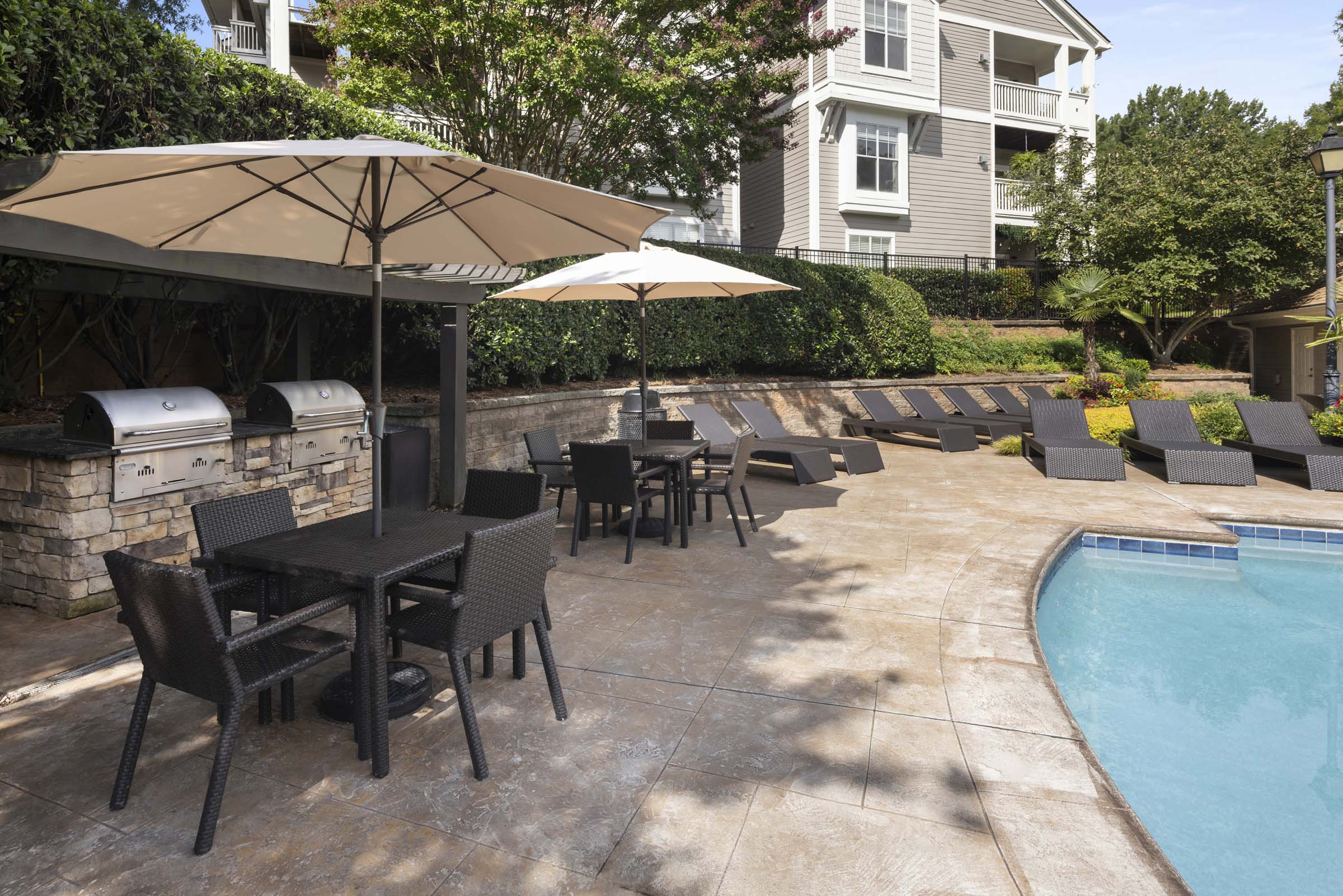 BBQ grills by the pool at Camden Sedgebrook apartments in Huntersville, NC