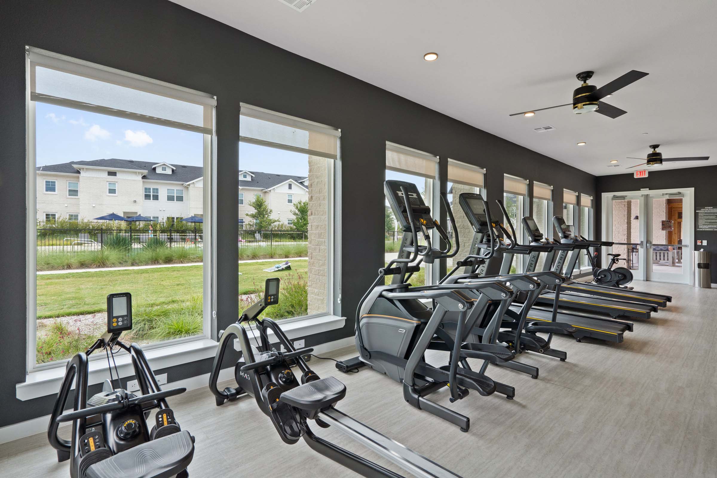 24-hour fitness center with large windows at Camden Leander apartments in Leander, Tx