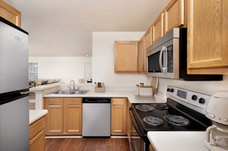 Kitchen with stainless steel appliances and upgraded lighting at Camden Touchstone in Charlotte, NC