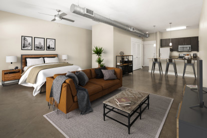 Loft-style living and bedroom at Camden Farmers Market Apartments in Dallas, TX