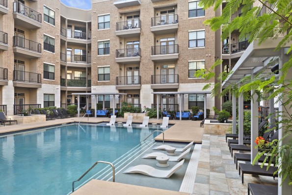 Resort-style pool with cabanas and in-water loungers at Camden Lamar Heights