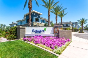 Landscaped flowers and grass near leasing office monument sign