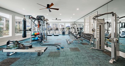 24- hour Fitness Center with rowing machine, cardio equipment, and free weights
