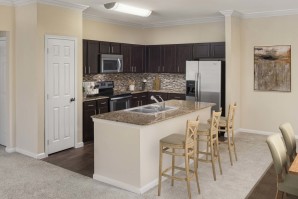 Vista style kitchen with granite countertops crown molding and stainless steel appliances