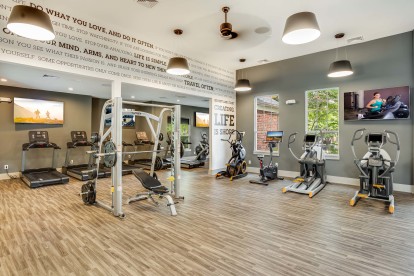 24 hour fitness center with cardio equipment and smith machine
