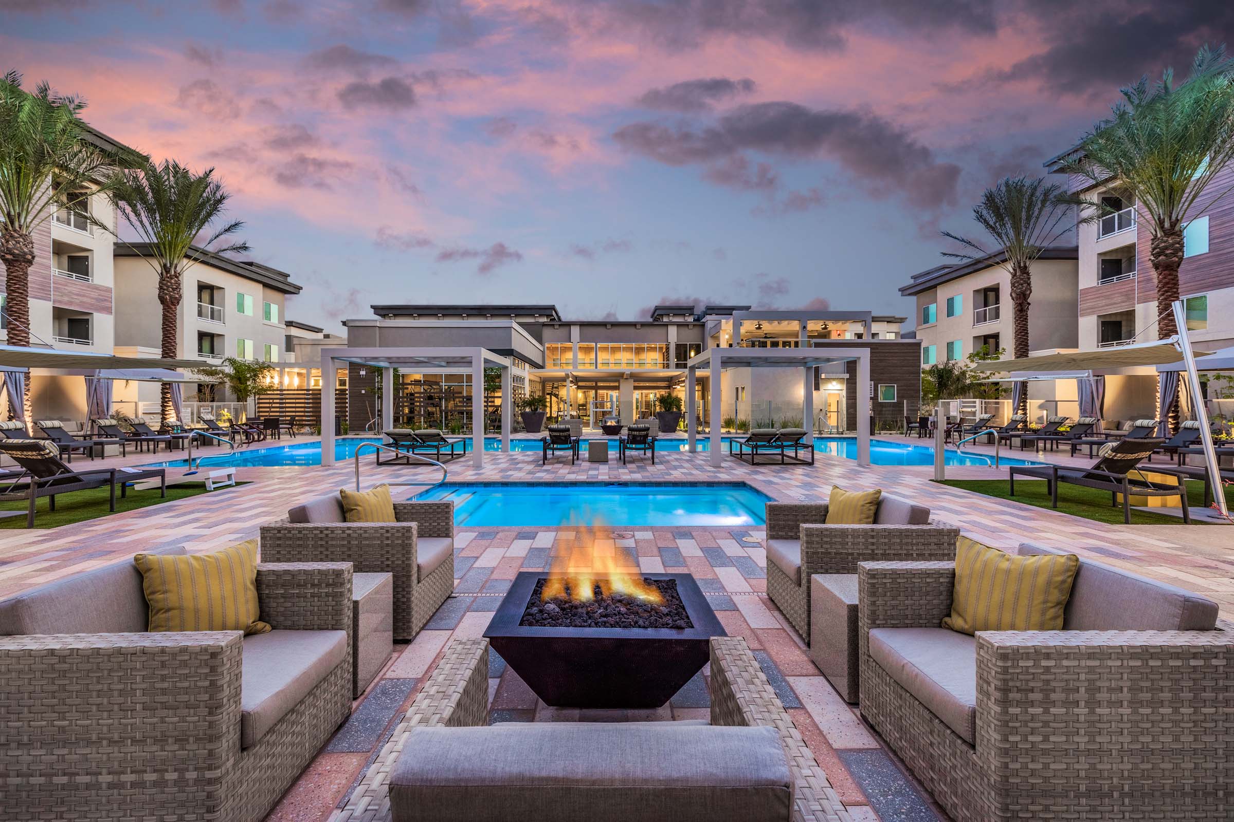 Swimming pool fire pit and seating area dusk