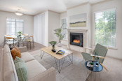 Open concept living room with a gas fireplace and dining room area