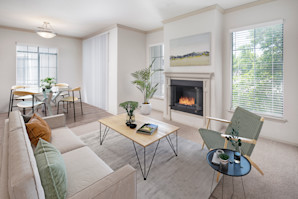 Open concept living room with a gas fireplace and dining room area