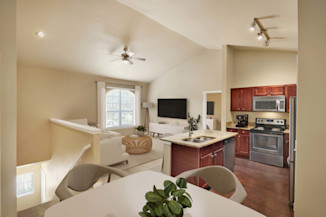 Top-floor townhome style apartment with vaulted ceilings and private stair entry at Camden Brushy Creek apartments in Cedar Park, TX