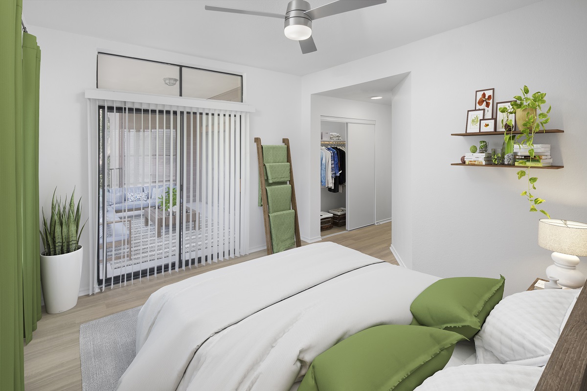 Bedroom with wood-style floors throughout and patio access