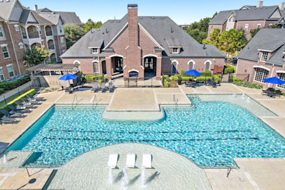 Resort-style pool with water features and sun loungers