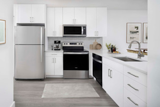 Modern interior finishes with white cabinets, stainless steel appliances and white quartz countertops in the alberti floorplan at camden portofino in pembrooke pines, fl. 