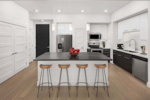 Camden McGowen Station with stainless steel appliances, pendant lighting and room for seating