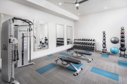 24-hour fitness center weight area at Camden Farmers Market apartments in Dallas, TX