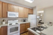 Traditional-style kitchen with Laminate Countertops and White Appliances 