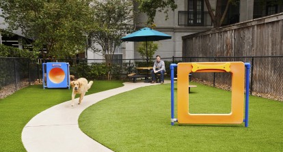 Private dog park with agility equipment at Camden Midtown Apartments in Houston, TX