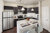 Kitchen with island and stainless steel appliances at Camden Franklin apartments in Franklin, TN