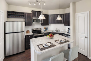 Kitchen with island and stainless steel appliances at Camden Franklin apartments in Franklin, TN