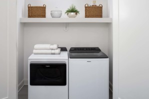 Full-size washer and dryer with built-in storage shelf