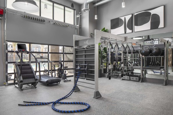 Camden Tempe West Apartments in Tempe Arizona 24-hour fitness center with rope trainer, stair master, and Gym Rax machine