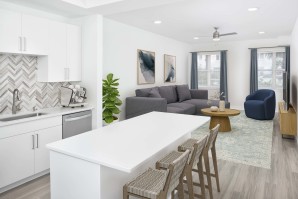 White contemporary apartment kitchen and living room with lots of natural light at Camden Grandview in Charlotte, NC