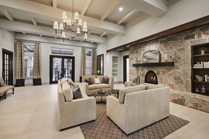 Resident lounge with seating and stone fireplace