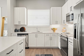 Spacious kitchen with white cabinets and window in 2-bedroom model at Camden Roanoke apartments in Roanoke, TX