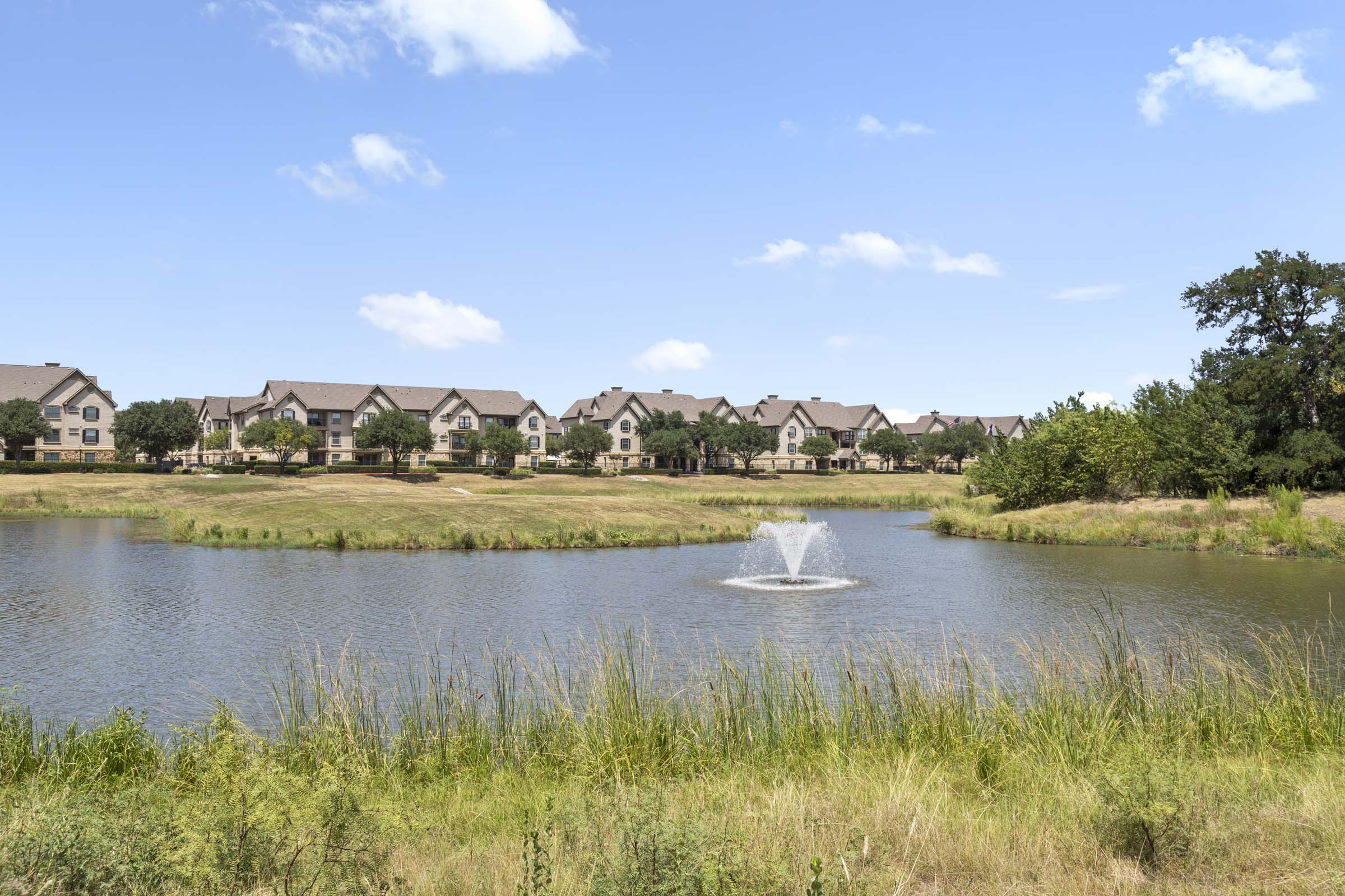 Onsite lake and surrounding nature trail at Camden Riverwalk apartments in Grapevine, TX