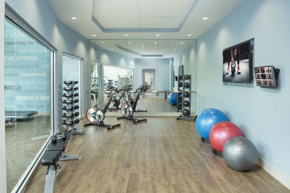 Yoga studio with spin bikes, free weights and TV.