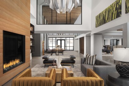 Double height resident lounge with fireplace and seating