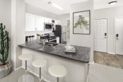 Kitchen with breakfast bar and stainless steel appliances at Camden Denver West Apartments in Golden, CO