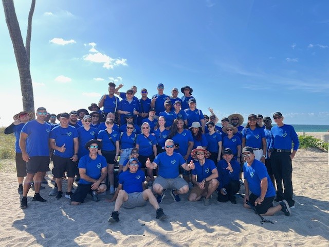 Camden team members group photo at beach cleanup event in South Florida