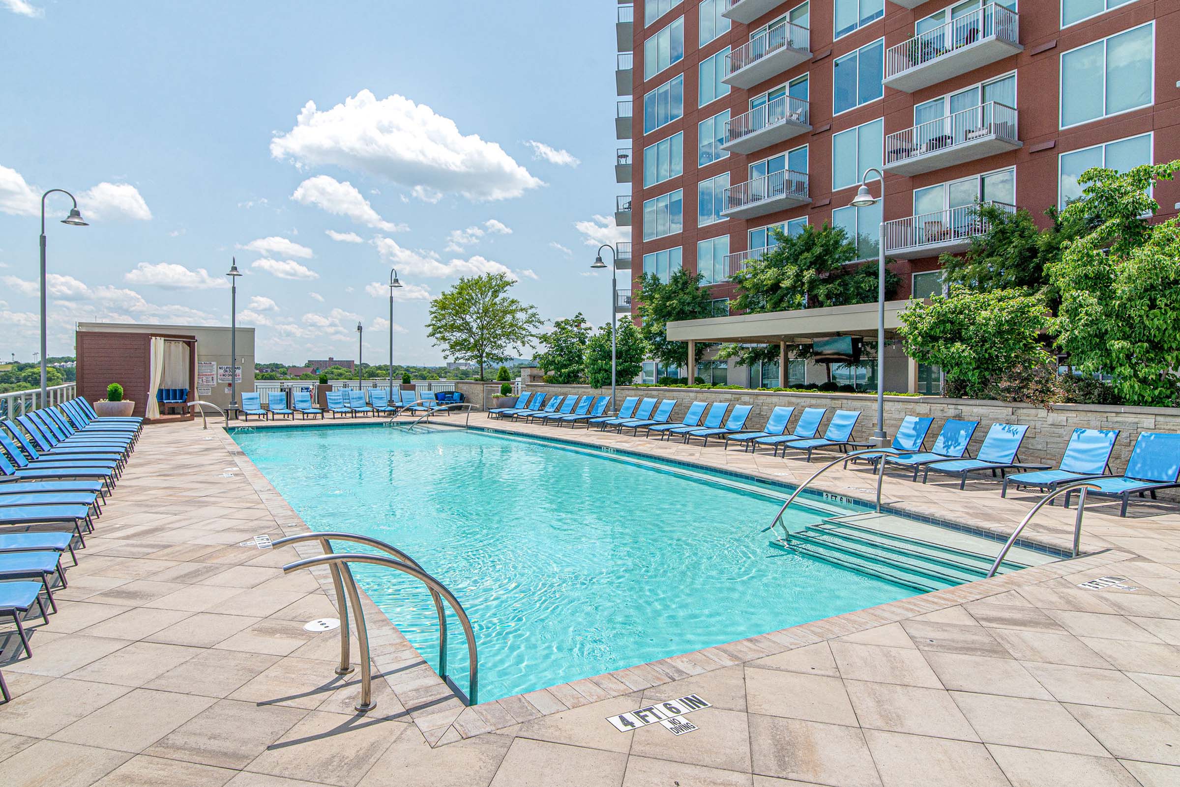 Rooftop pool with cabanas and lounge seating