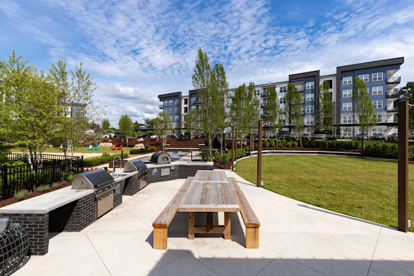 Outdoor kitchen next to the event lawn and volleyball court at Camden West Nashville apartments in Nashville, TN