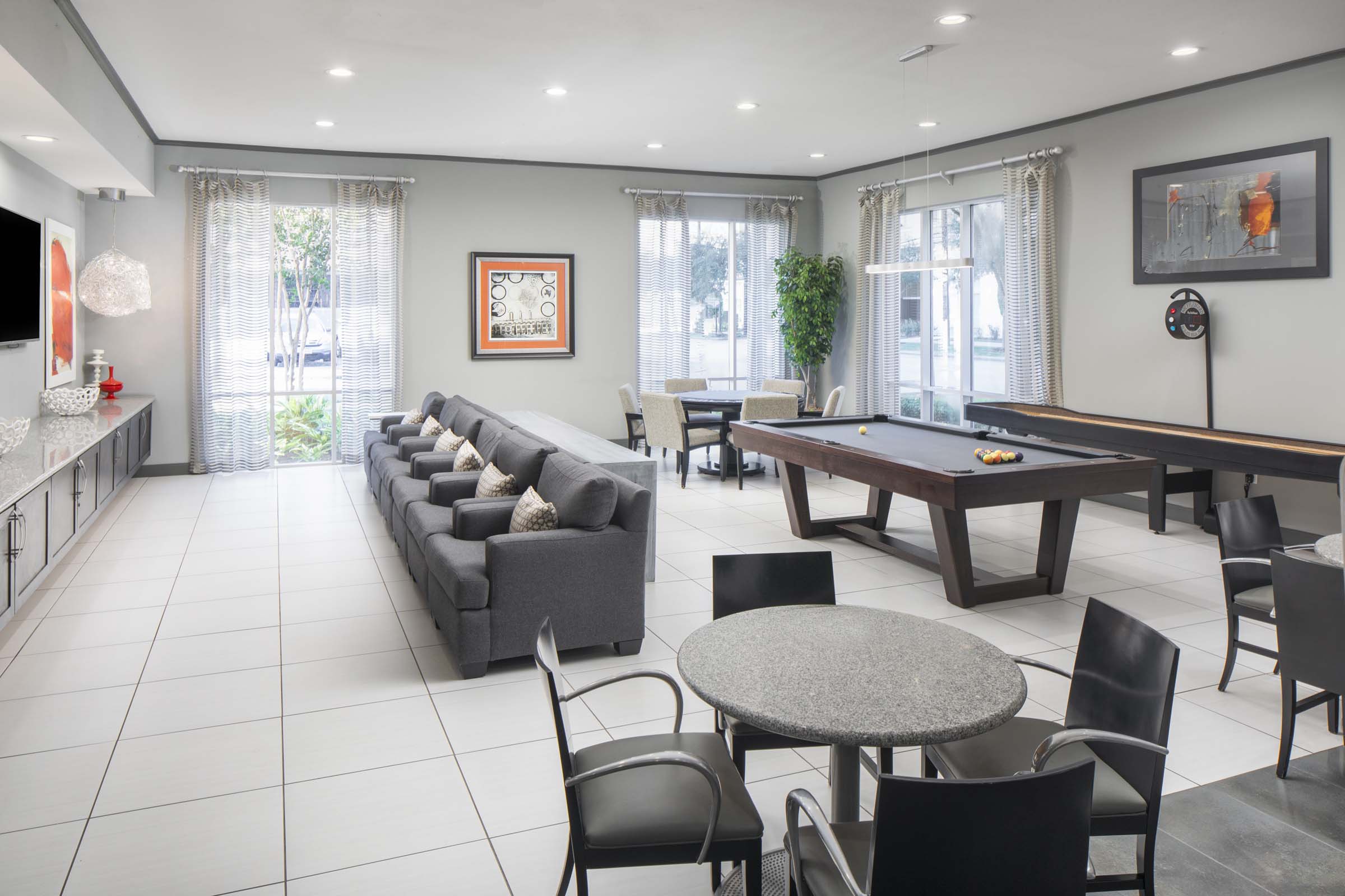 Game room with billiards and shuffleboard at Camden Travis Street Apartments in Midtown Houston, Tx