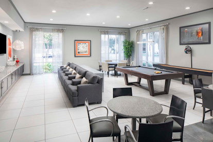 Game room with billiards and shuffleboard at Camden Travis Street Apartments in Midtown Houston, Tx